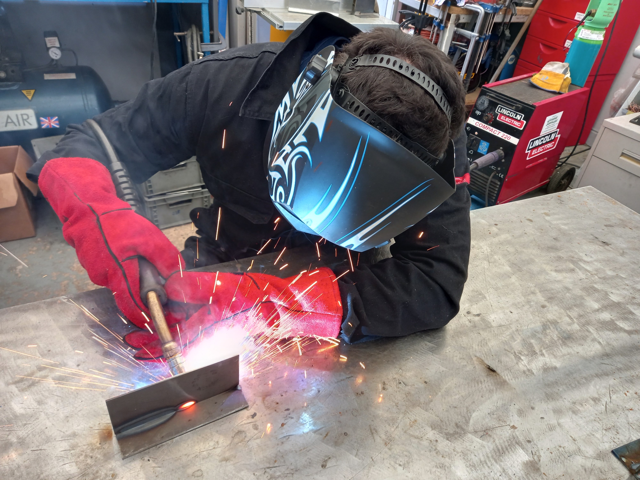 Red and black welding student on different angle