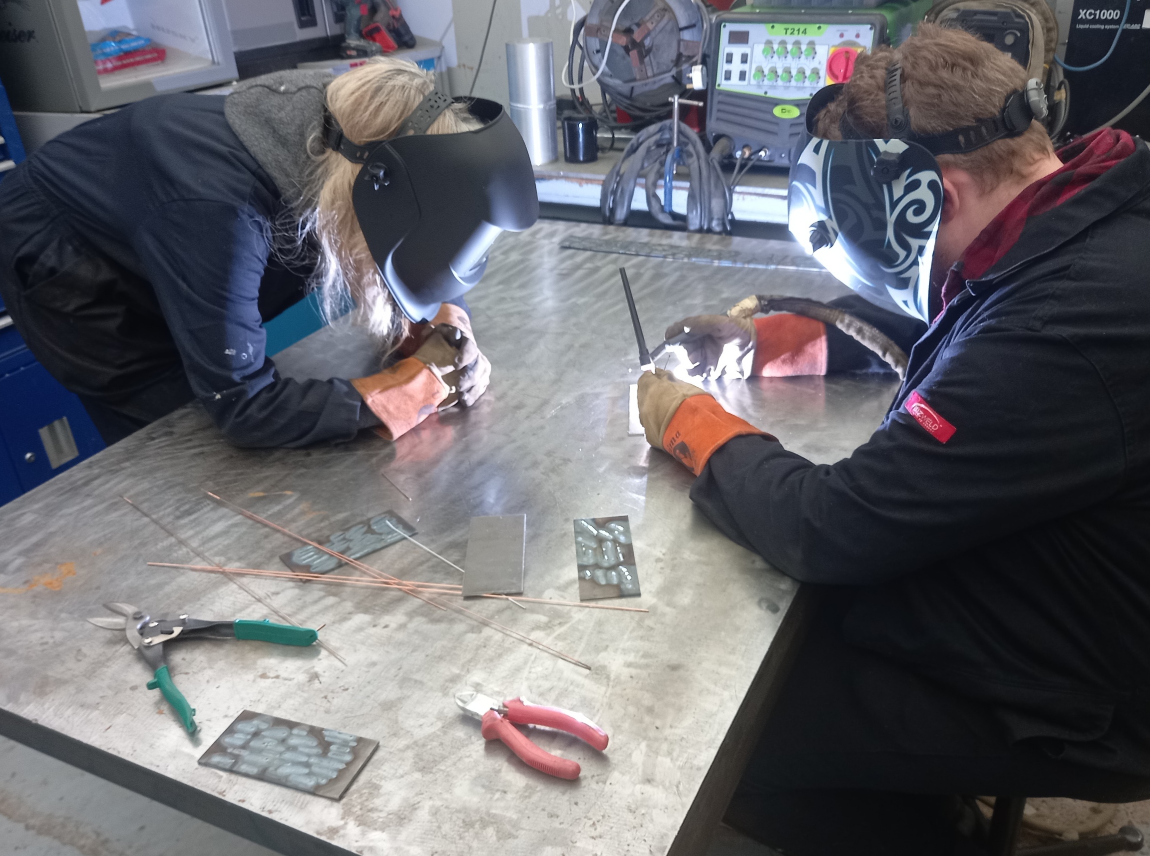 Couple welding setting in workshop