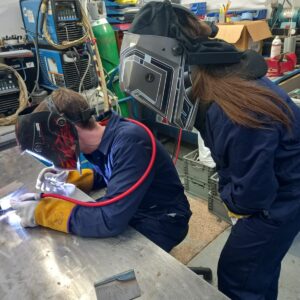 A couple welding as a part of their full day workshop with Nige Andrews